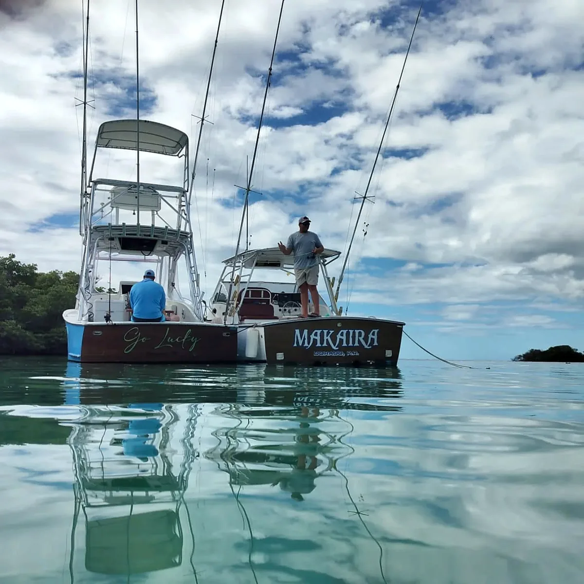 Two offshore charter boats reflected in calm water near Cabo Rojo.