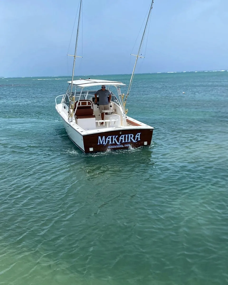 Makaira offshore charter boat cruising through clear Cabo Rojo water.
