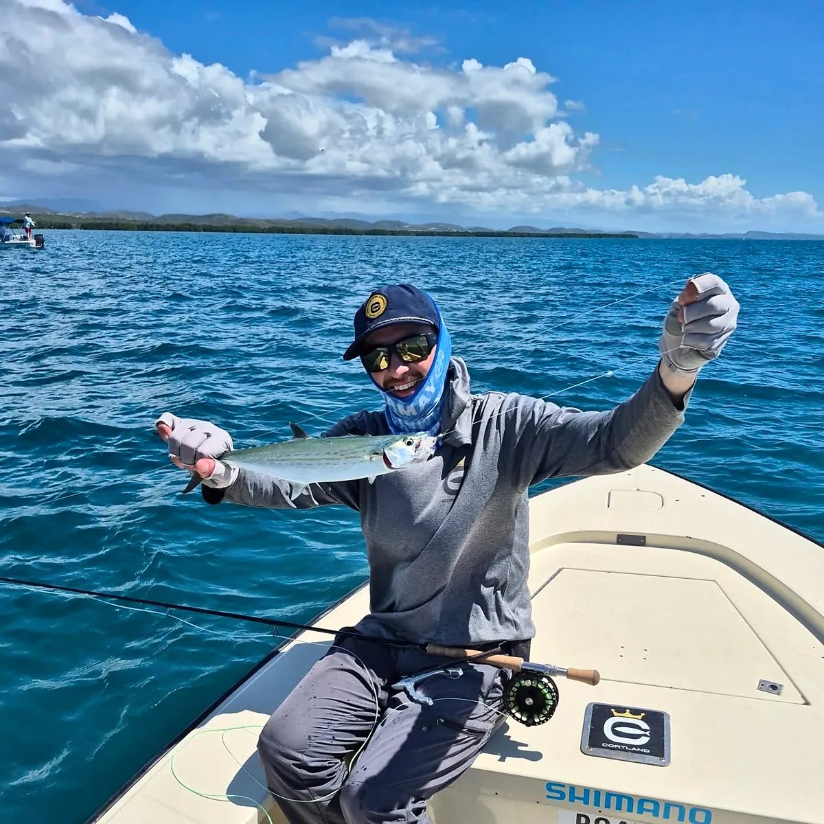 Smiling angler displaying a catch while fly fishing near Cabo Rojo.