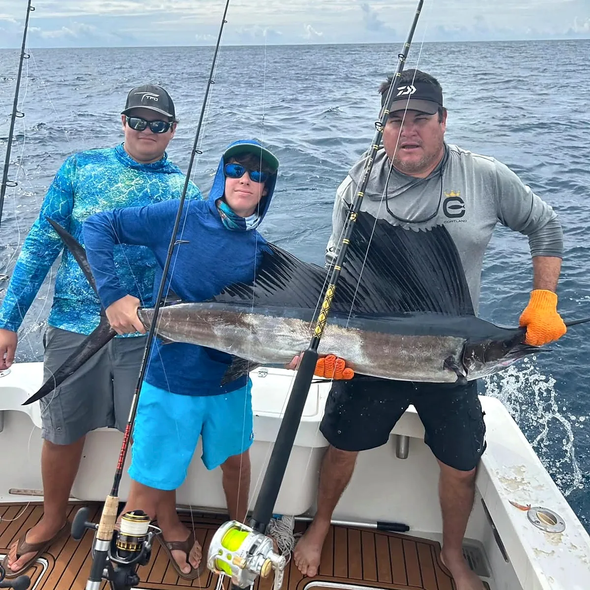 Young angler and crew displaying a sailfish aboard a Puerto Rico charter boat.