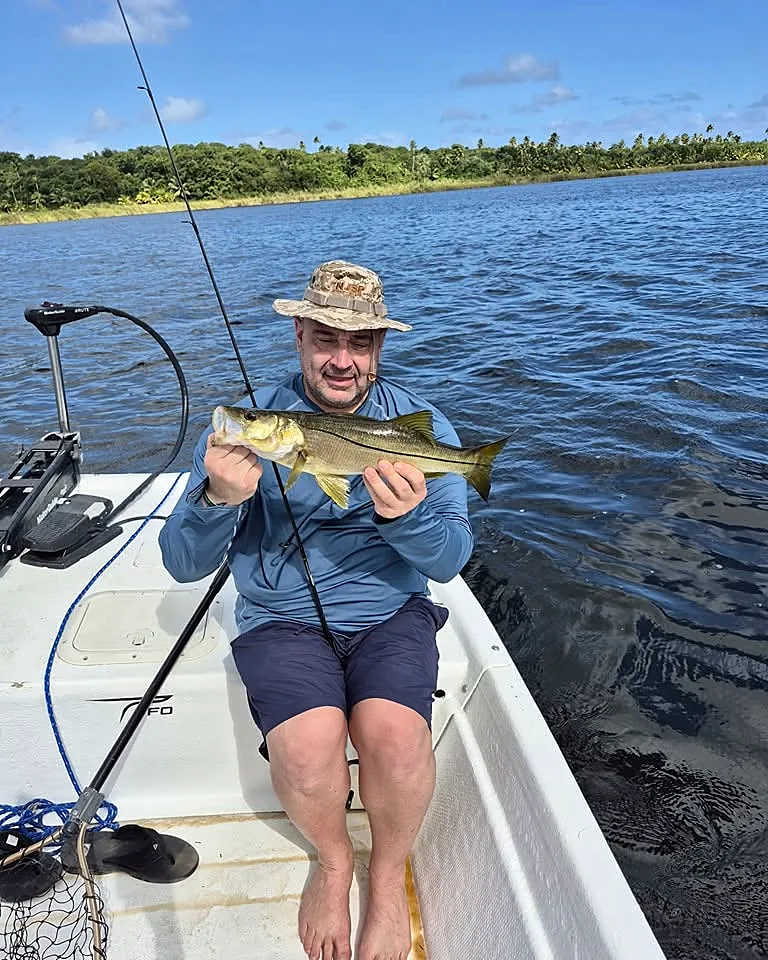 Angler holding an inshore catch from a small skiff near Cabo Rojo.