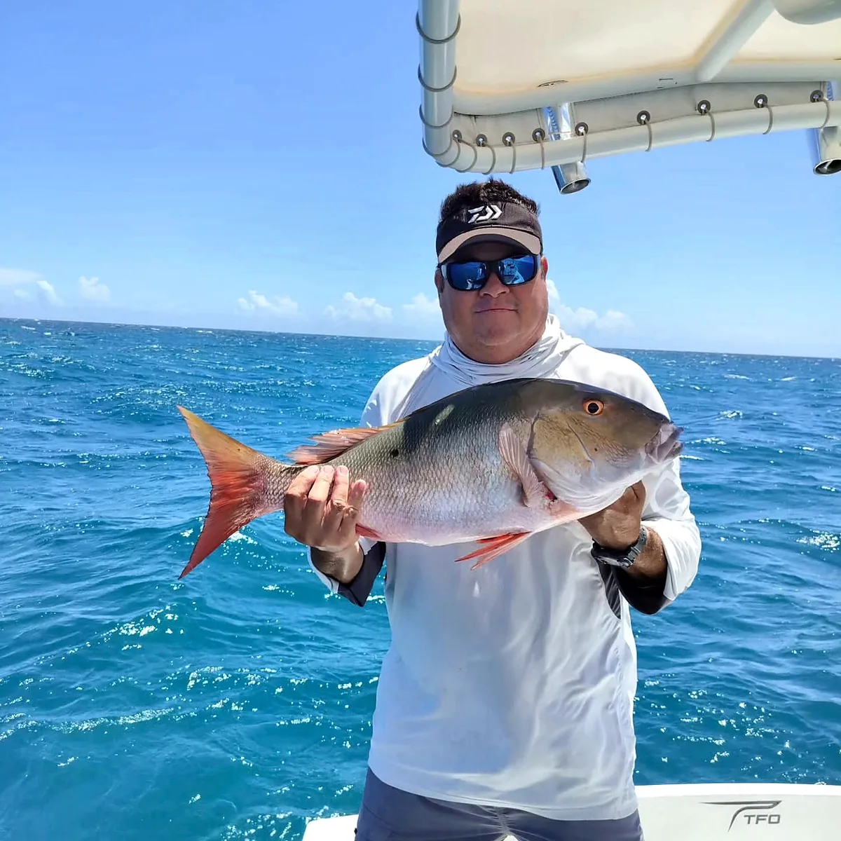 Captain displaying a large reef catch on a Cabo Rojo charter.