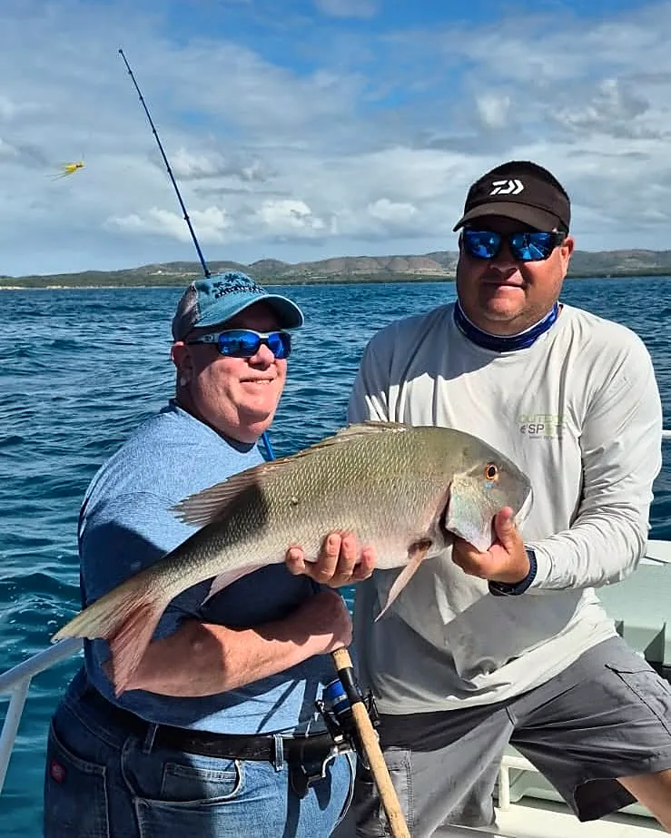 Guest and captain holding a large reef fish on a Puerto Rico charter.