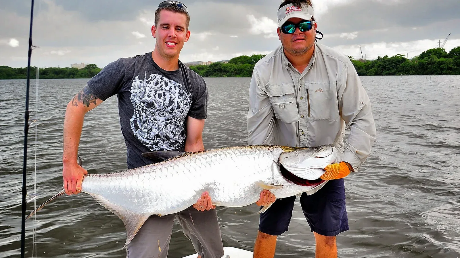Anglers with a tarpon caught on a private Puerto Rico fishing charter